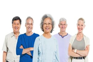 A group of elderly men and women standing and smiling for the camera